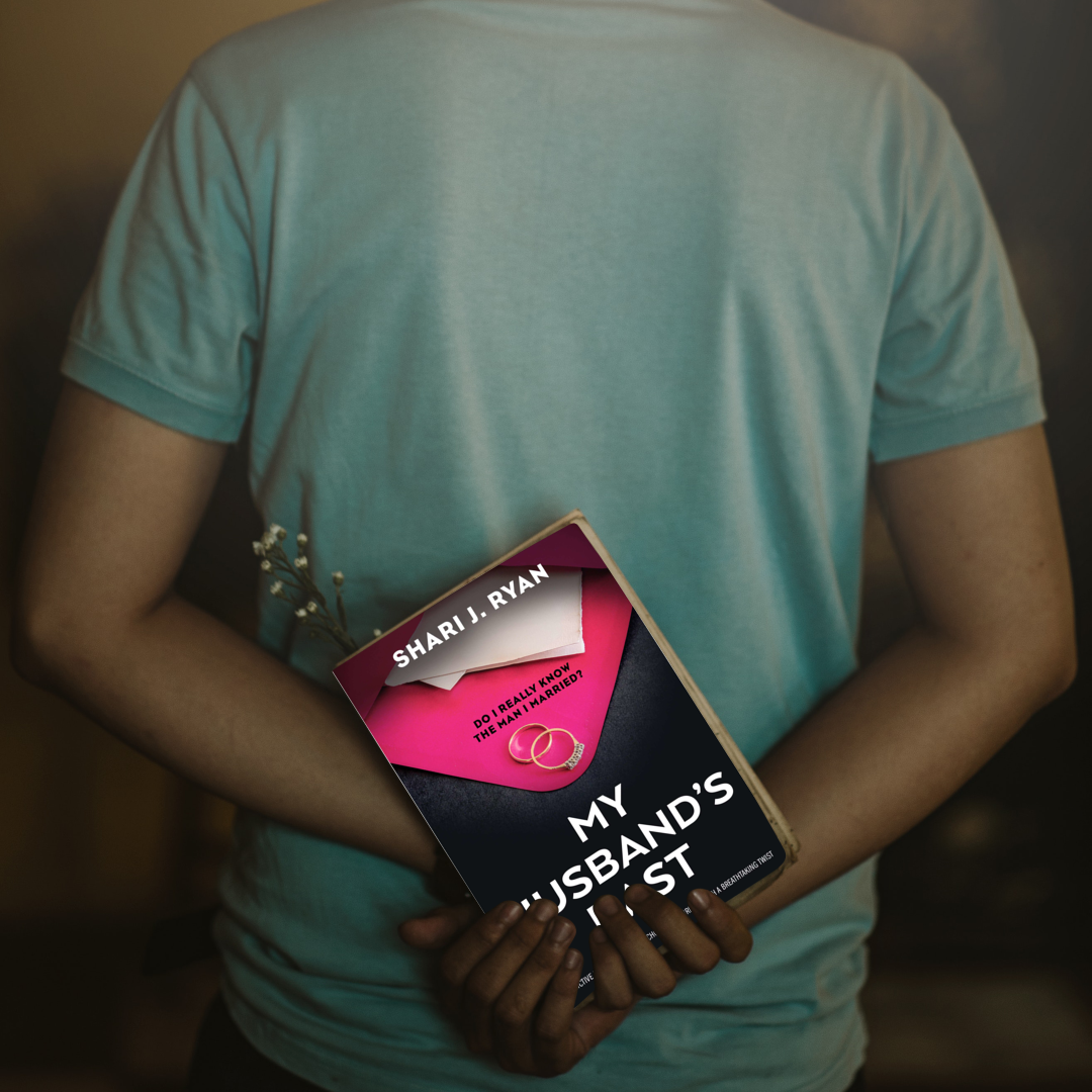 A man is holding a book titled my husband 's test