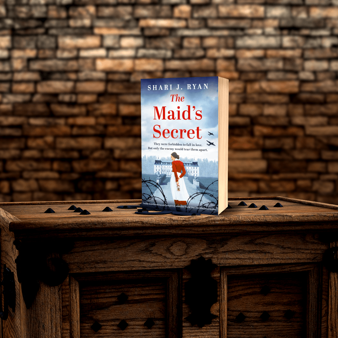 A book titled the maid 's secret sits on a wooden table