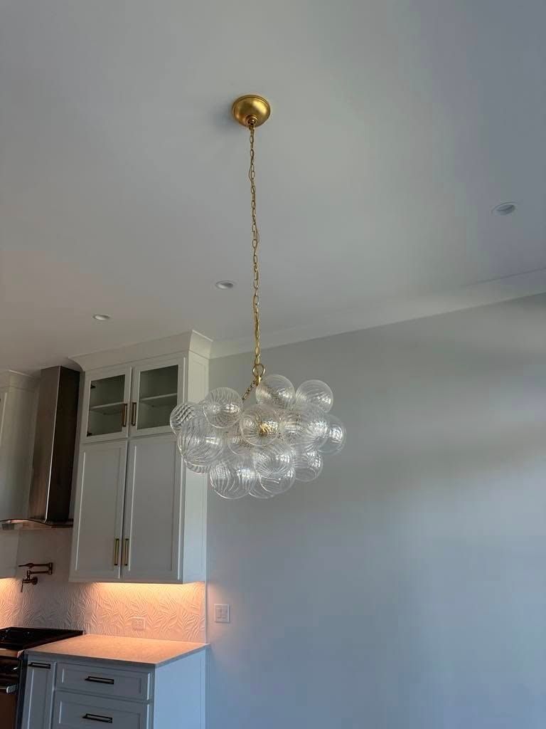 Gold and glass bubble chandelier hanging in a kitchen.