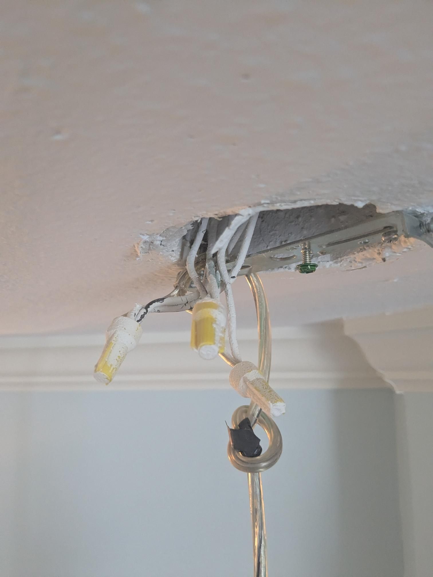 Ceiling wiring exposed after light fixture removal. White and black wires with wire connectors hang from the ceiling.