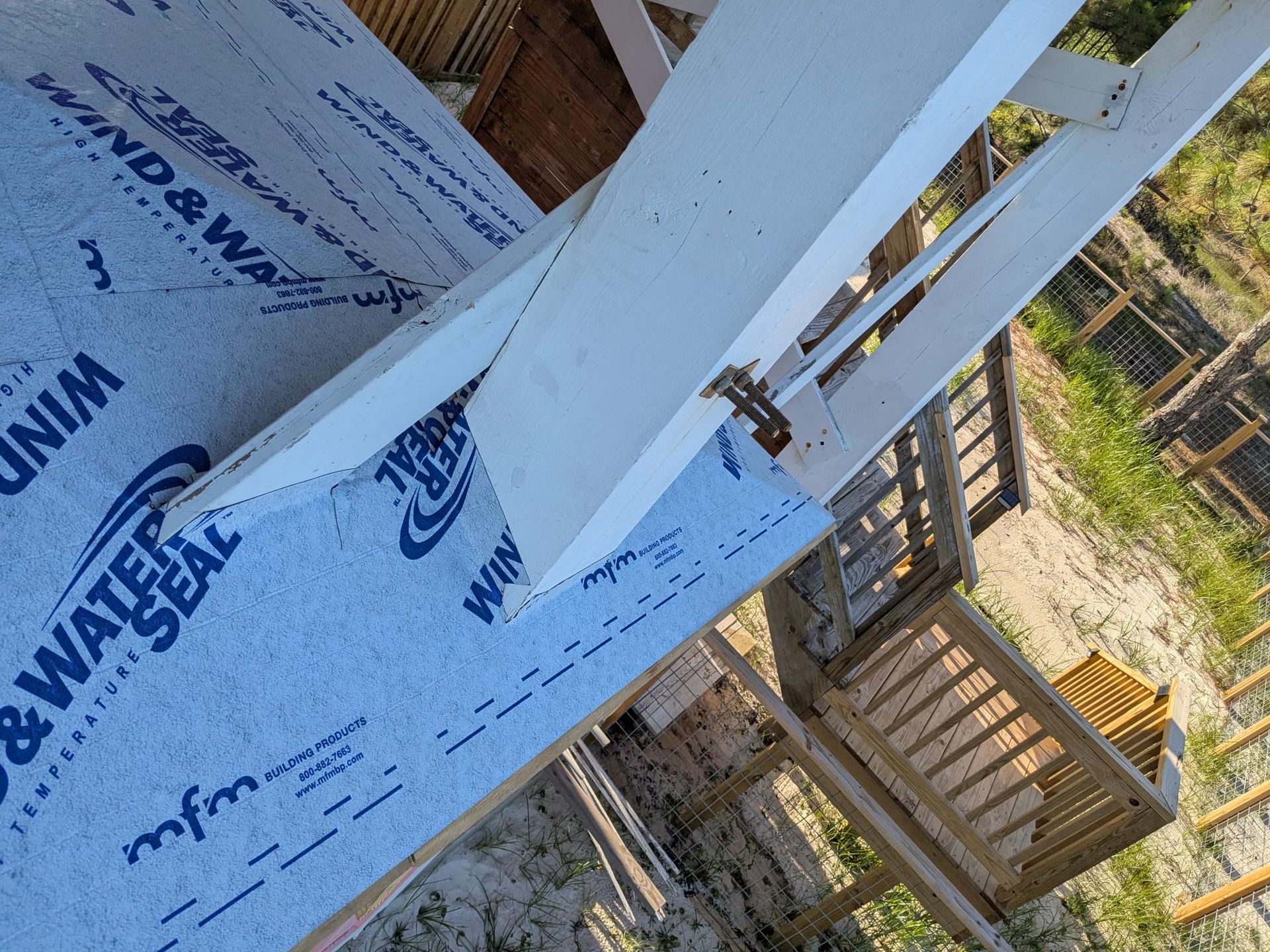 Blue wind and water seal with white beams of a structure being built.