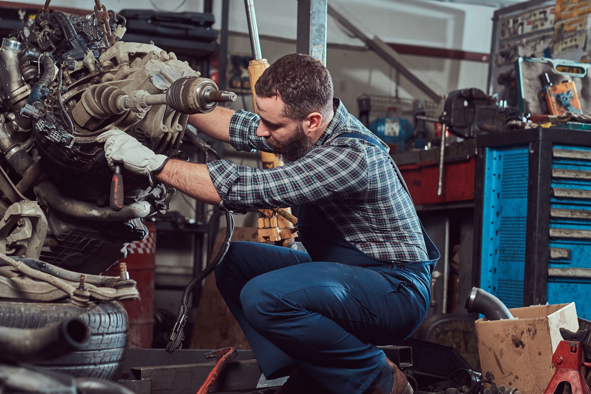 Mechanic specialist repairs the car engine.