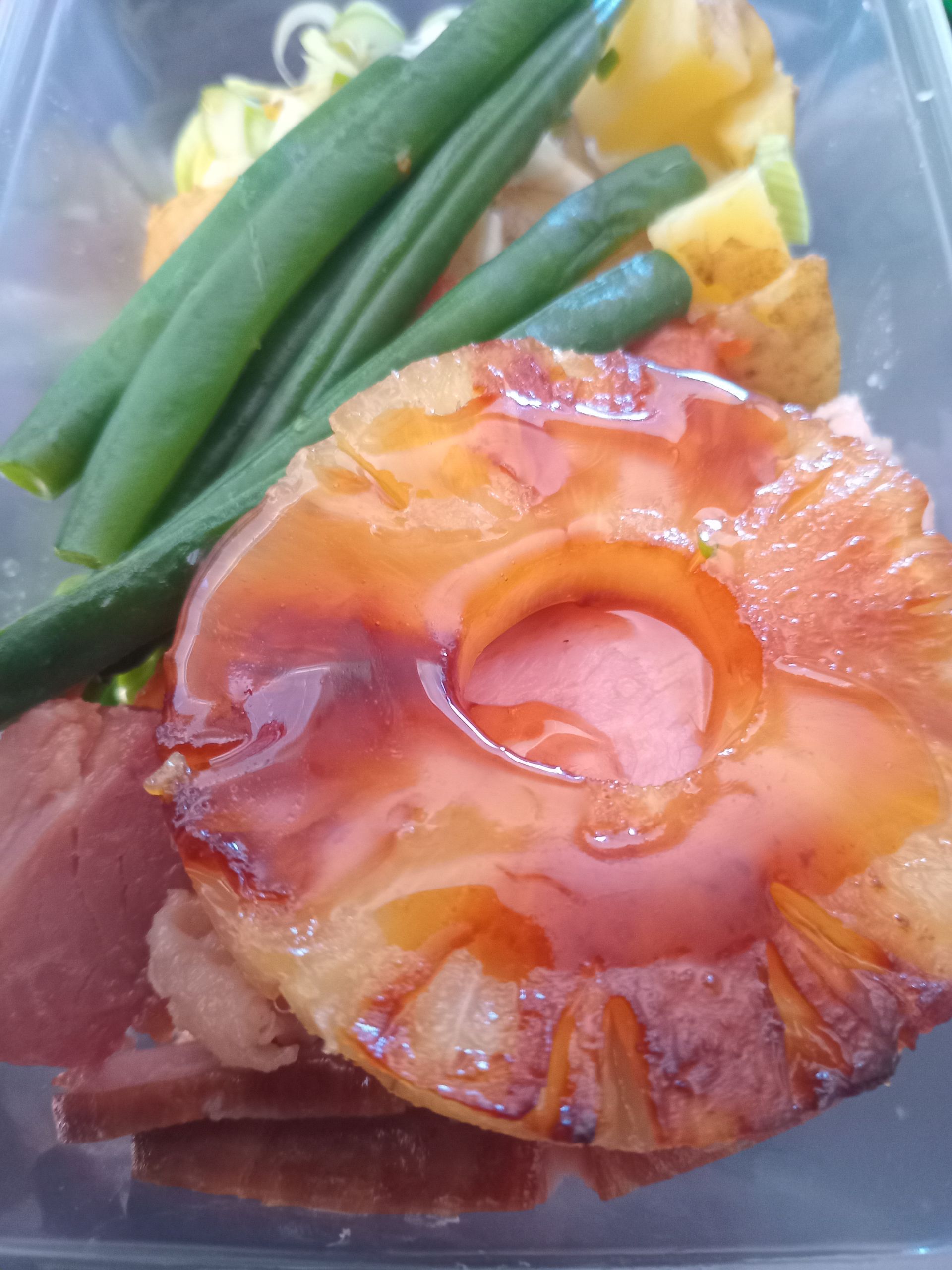 Ham with glazed pineapple, green beans, and roasted potatoes.