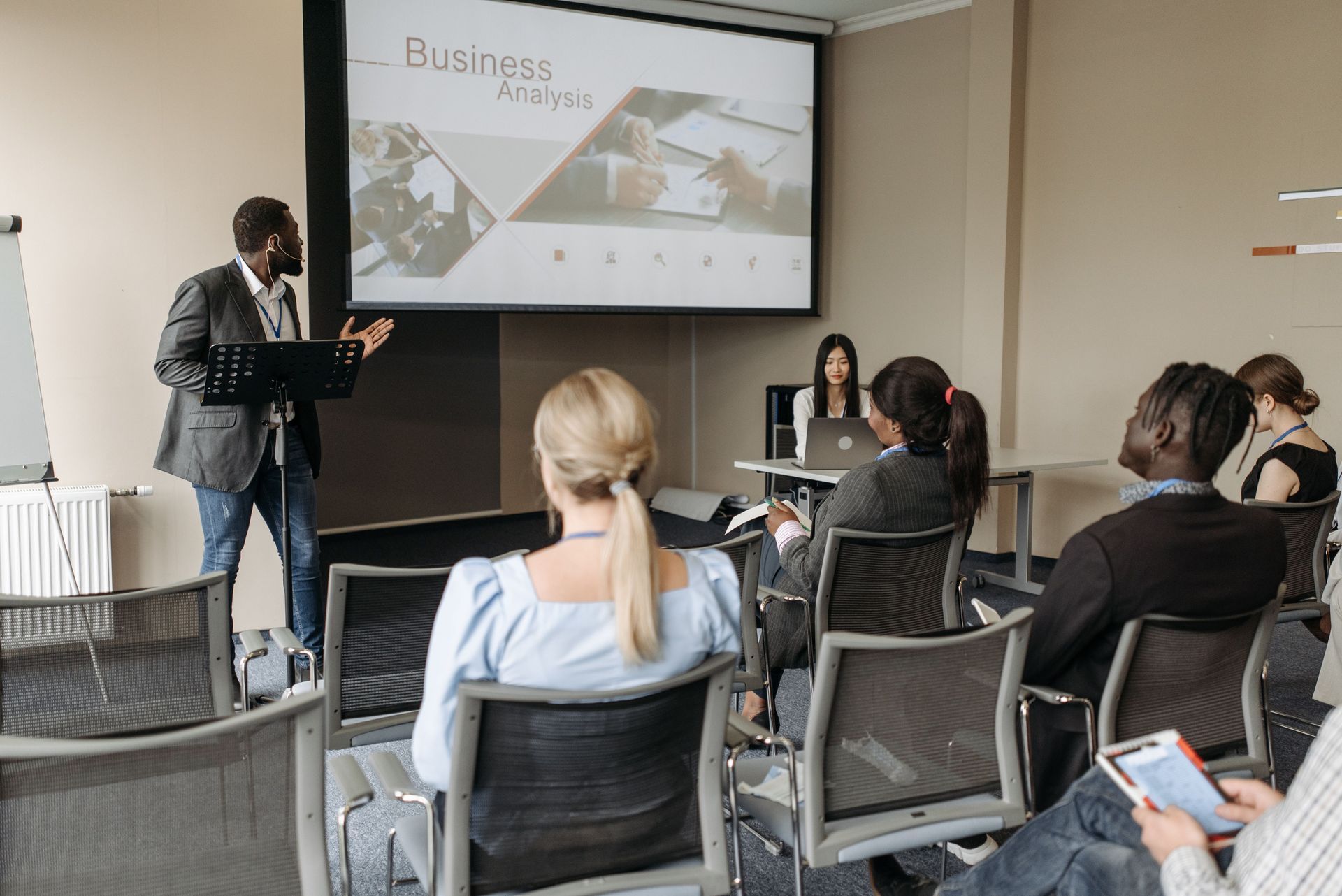 A group of employees and a trainer in a conference room participating in a training session