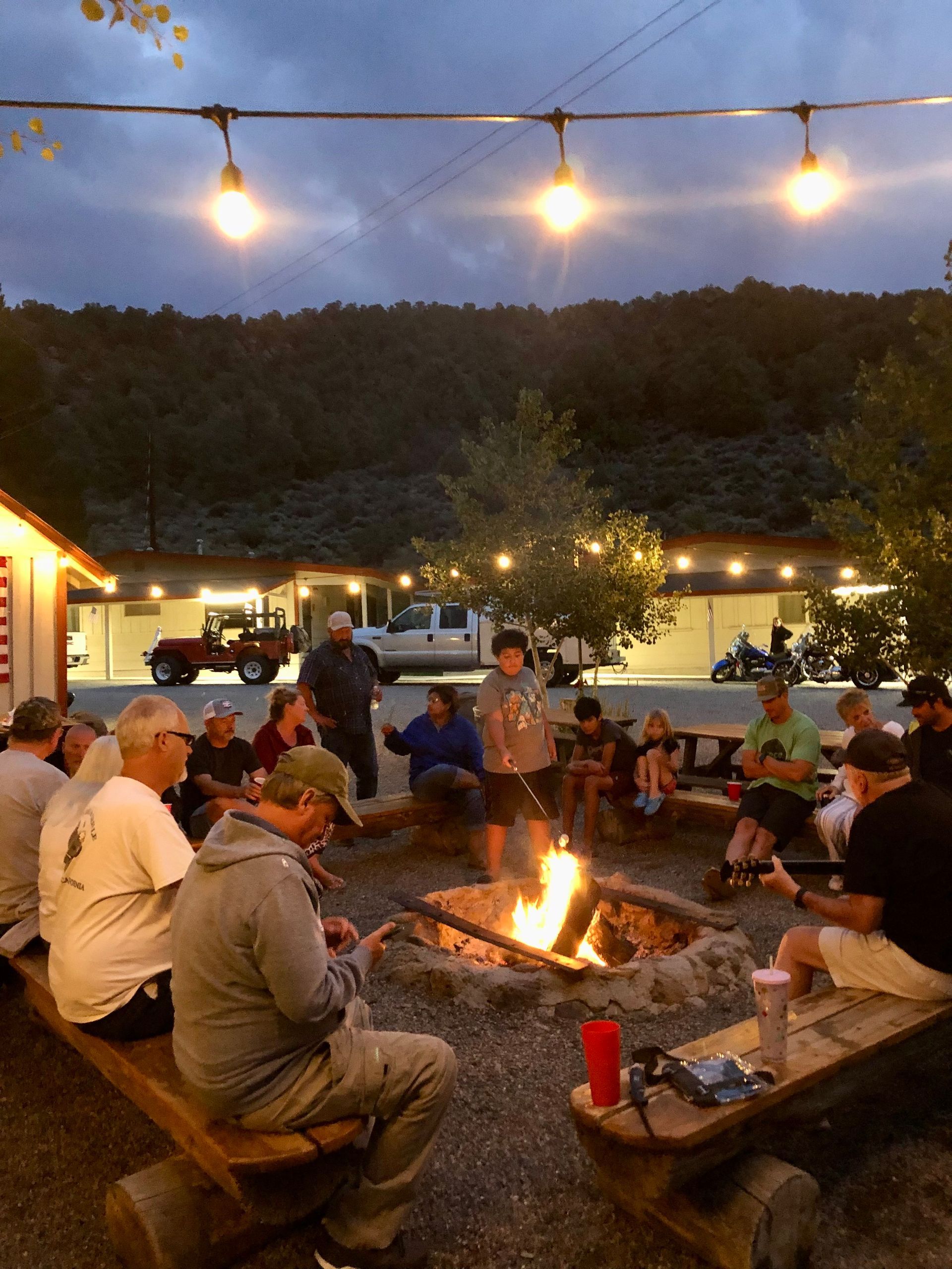 group-gathered-around-firepit-at-night