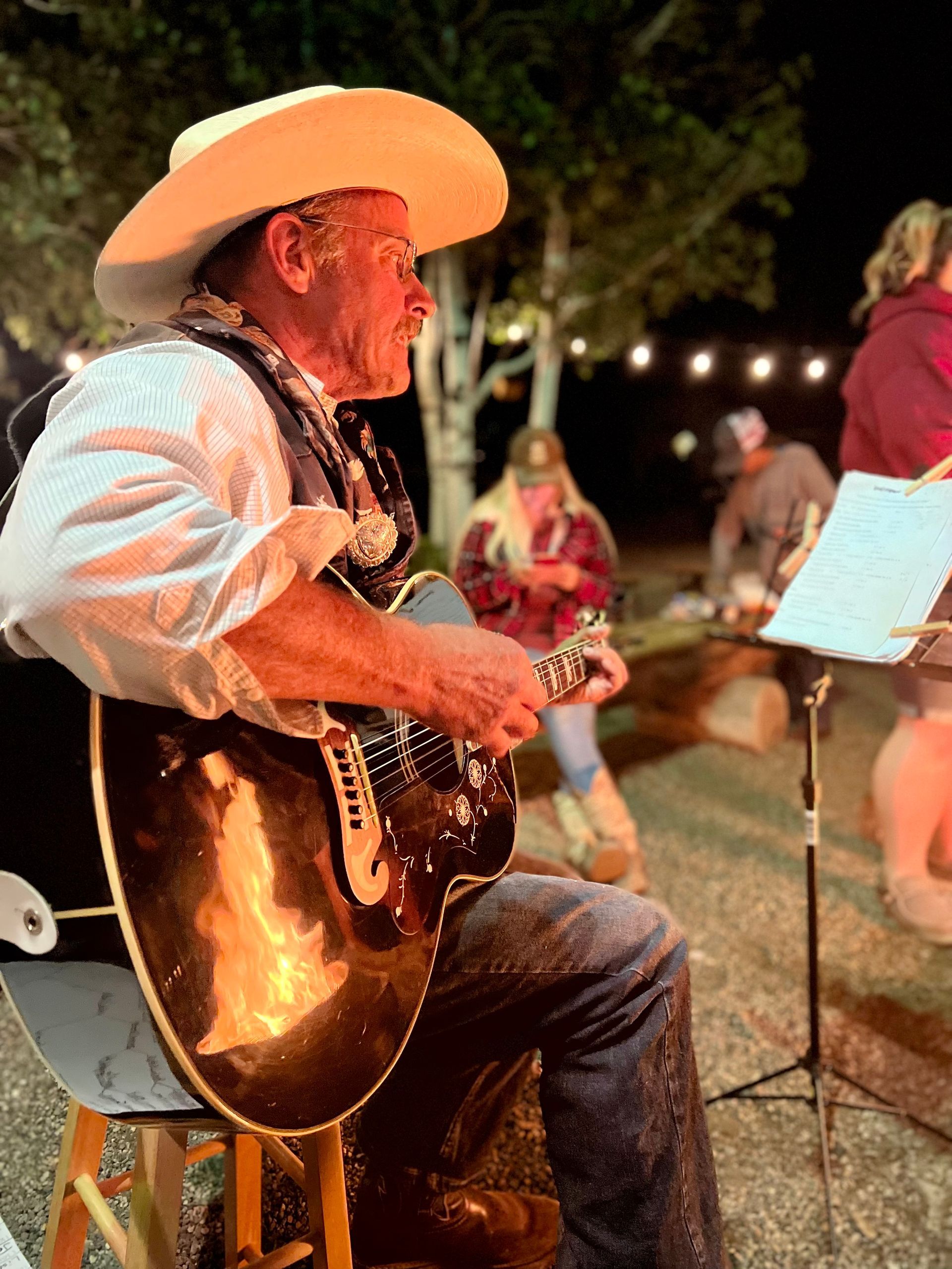 man-playing-guitar-at-campfire