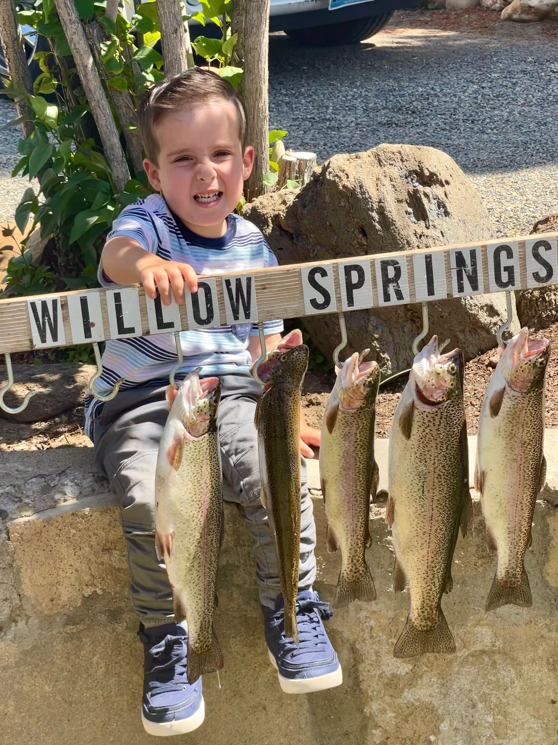 kid-holding-sign-with-caught-fish