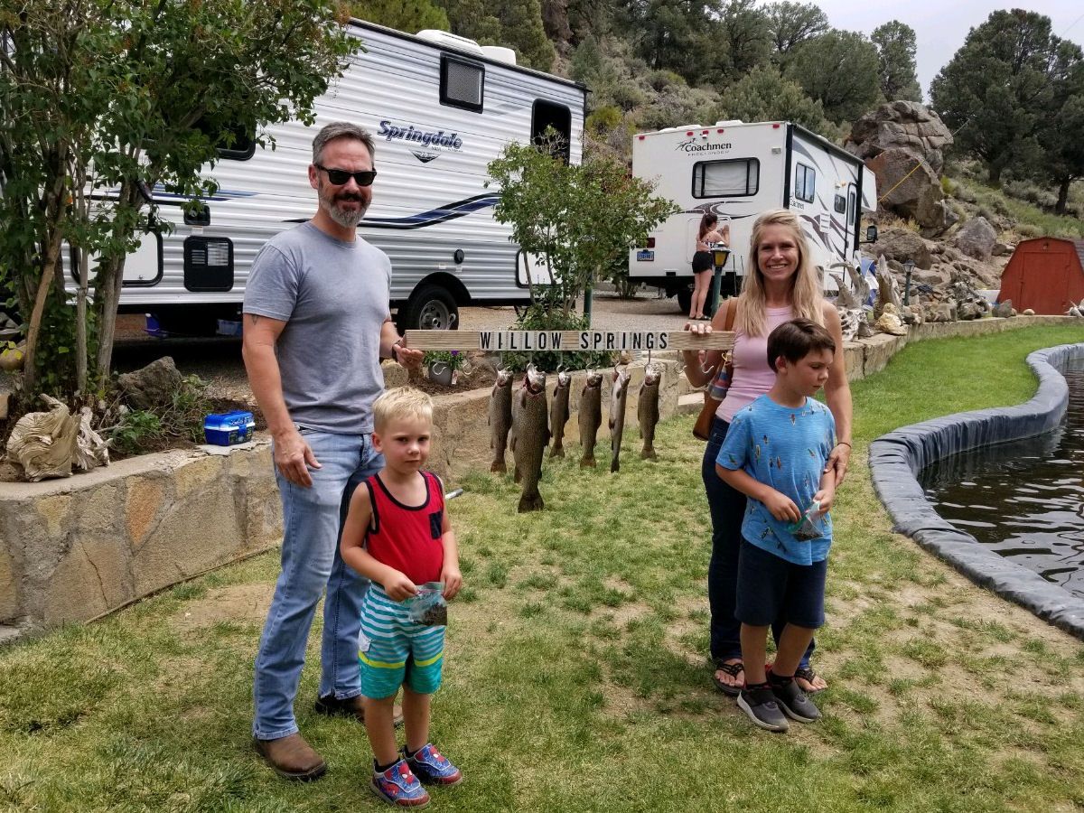 family-with-sign-and-caught-fish
