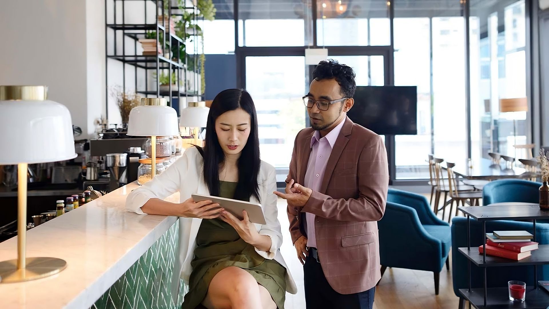 A Man and a Woman Are Looking at a Tablet