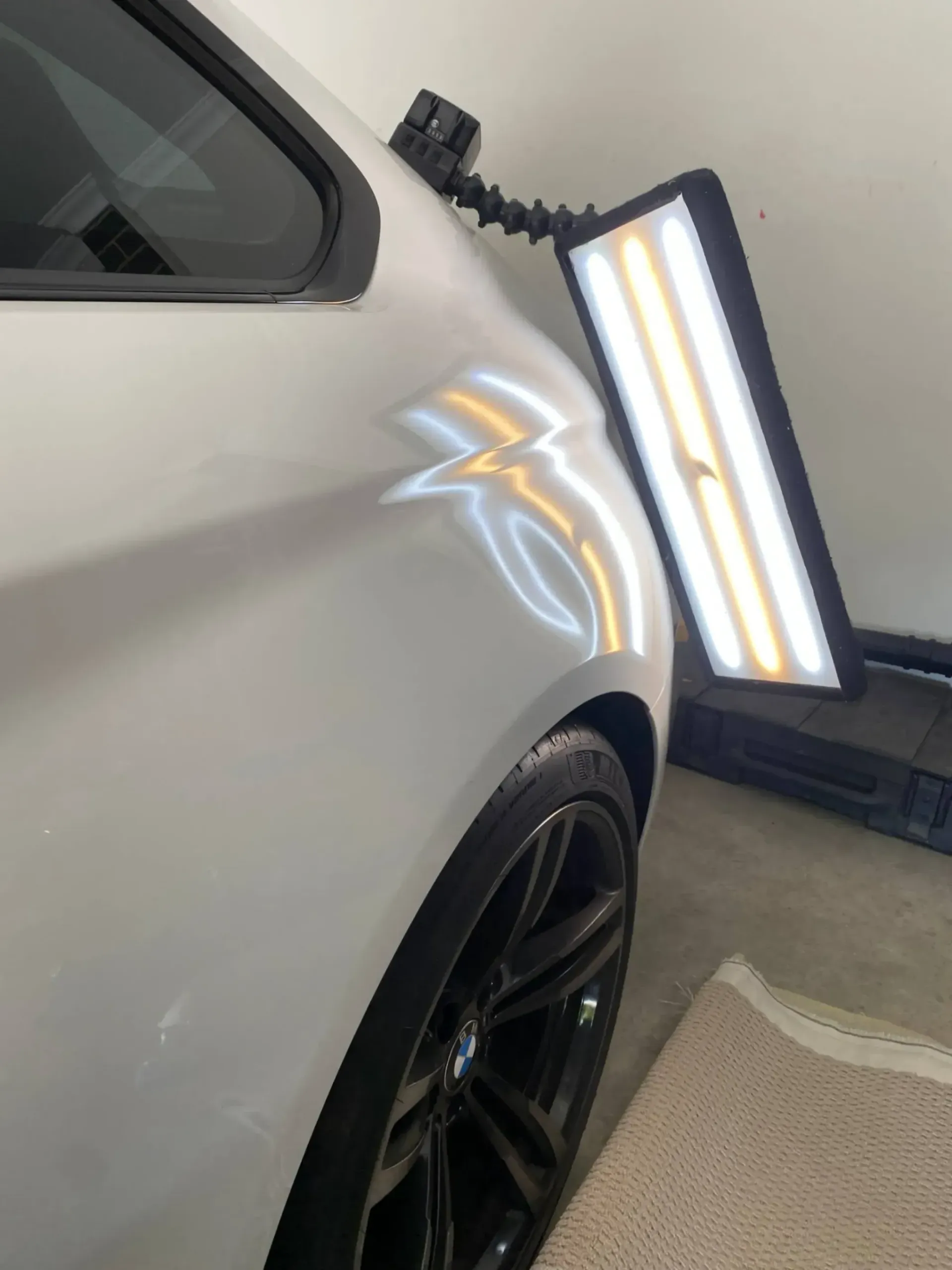 A close up of a car with a light on it with dents