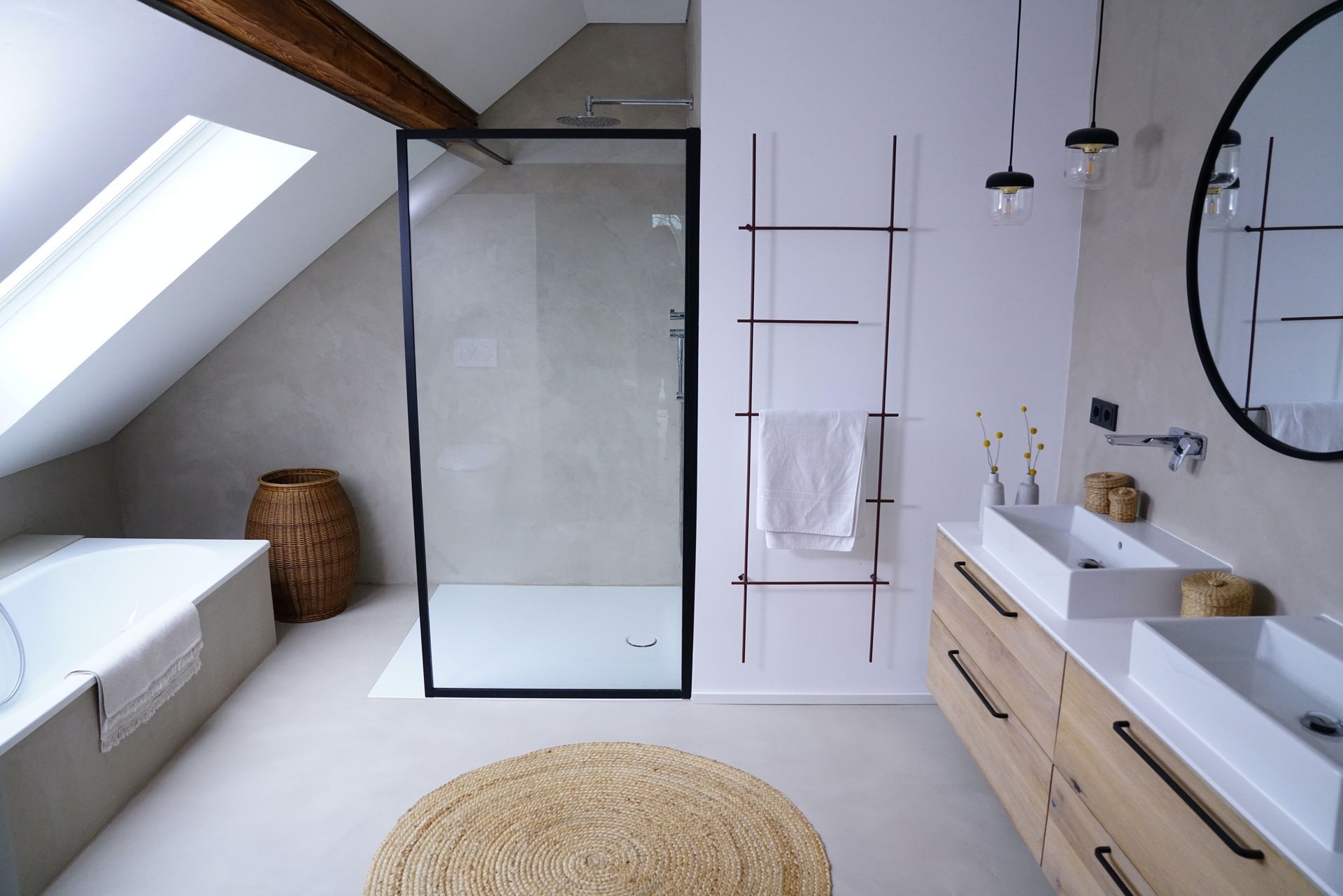 A bathroom with two sinks and a walk in shower
