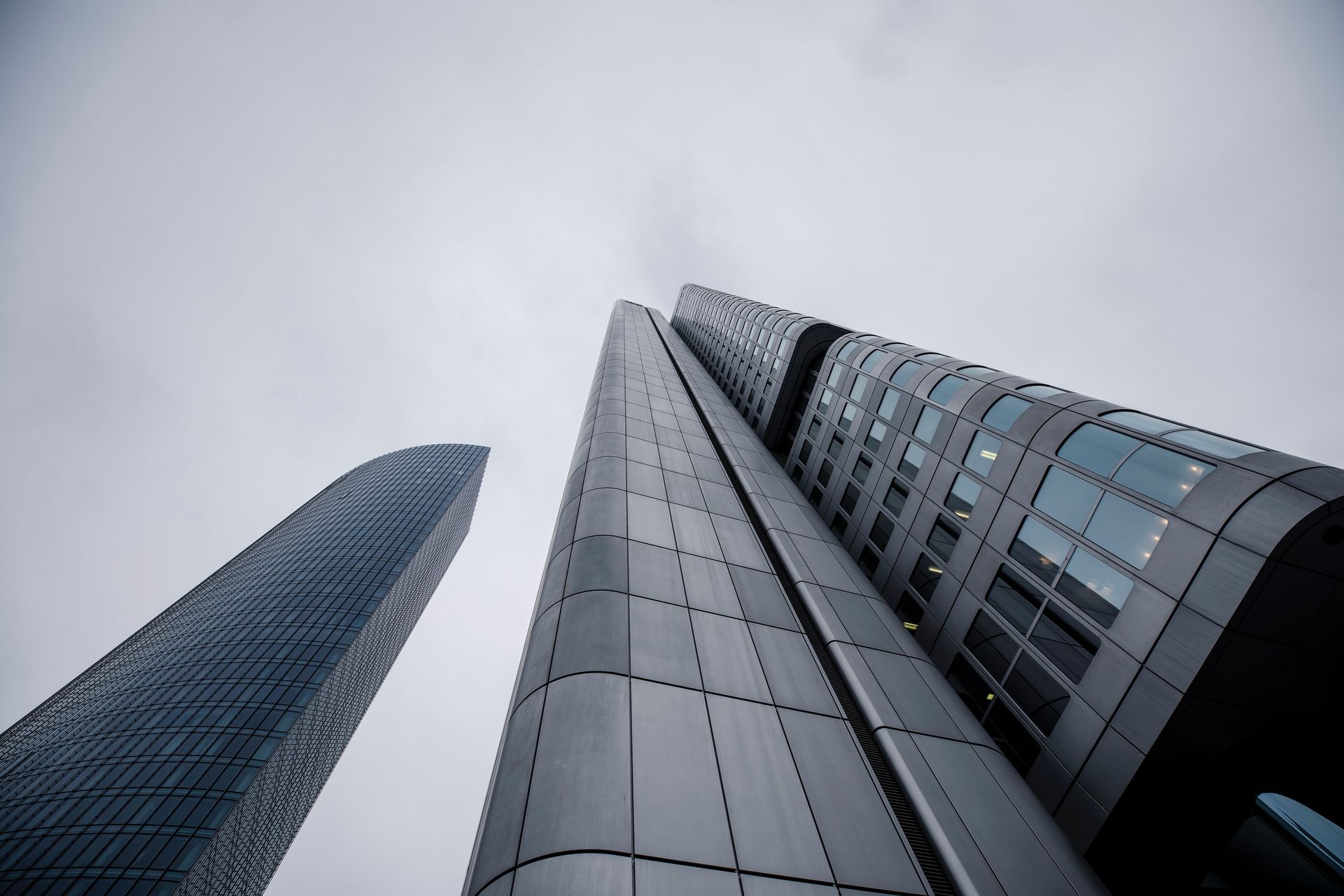 Looking up at a tall building with a cloudy sky in the background