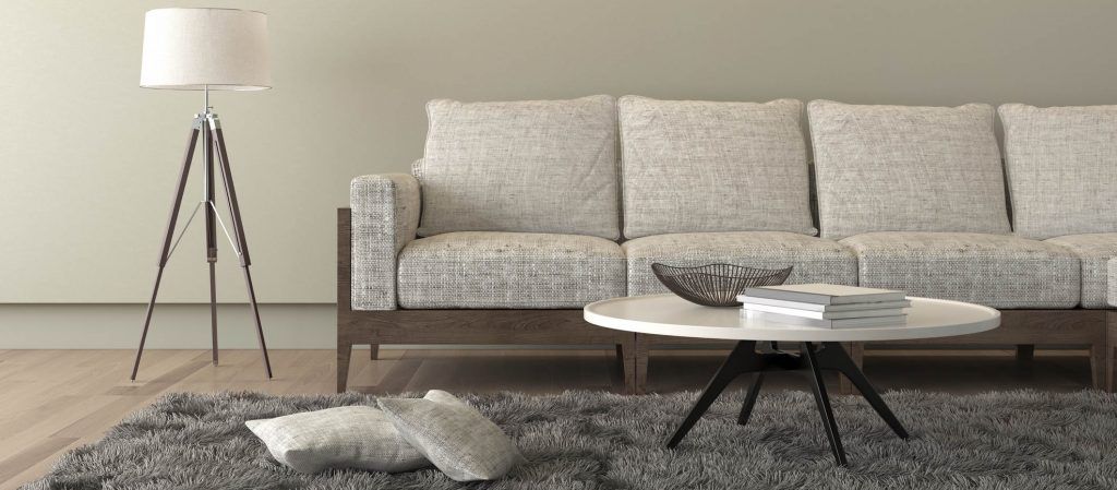 Beige sofa with a living room like setup around it
