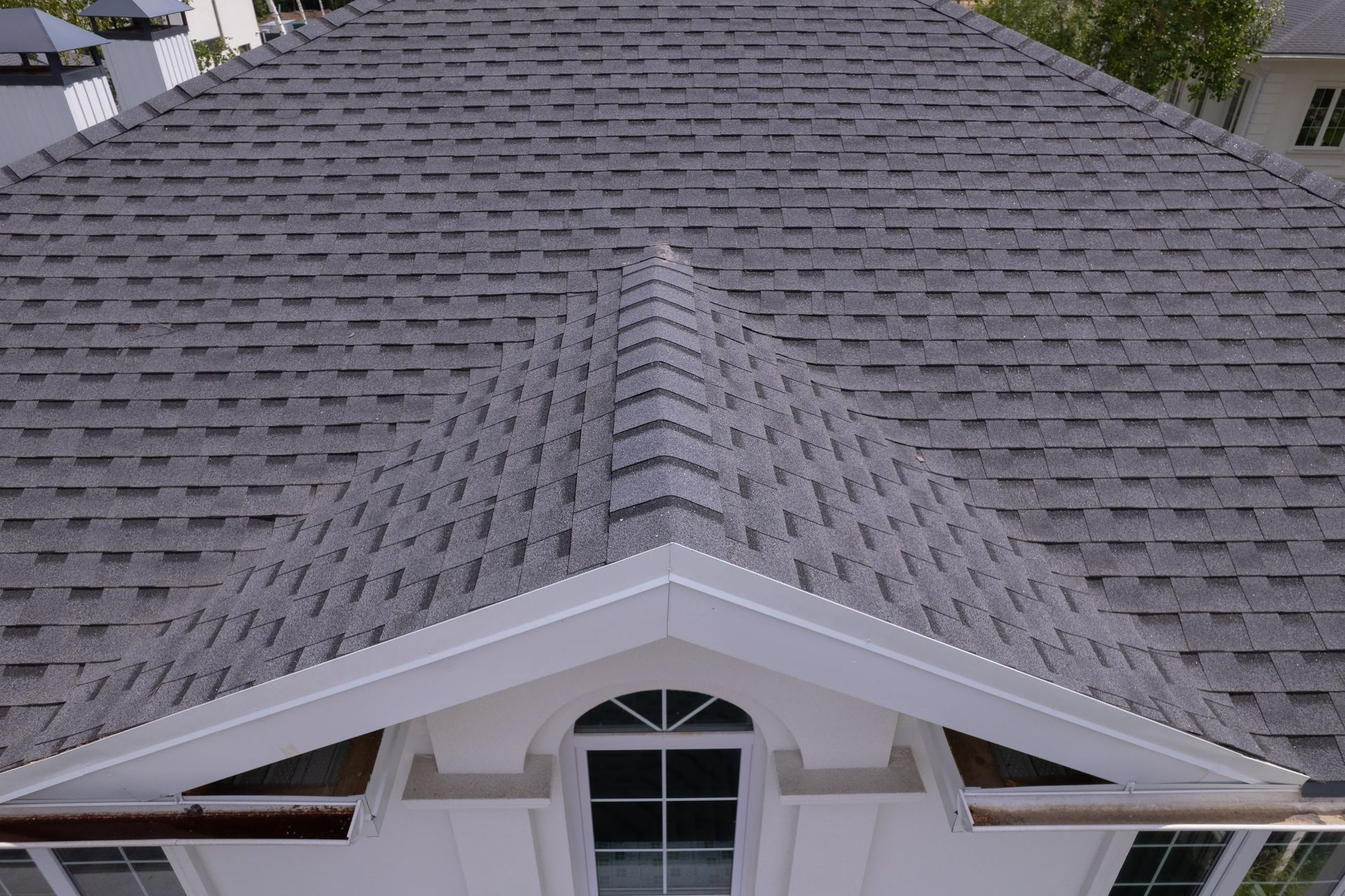 An aerial view of a house with a gray roof.