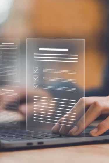 Hands typing on a laptop with a digital overlay showing document checklists and progress bars.