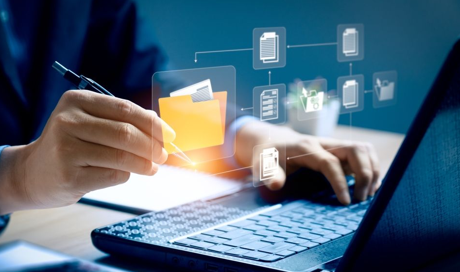 Hands work on a laptop with a digital overlay of a folder and document icons, symbolizing document management.