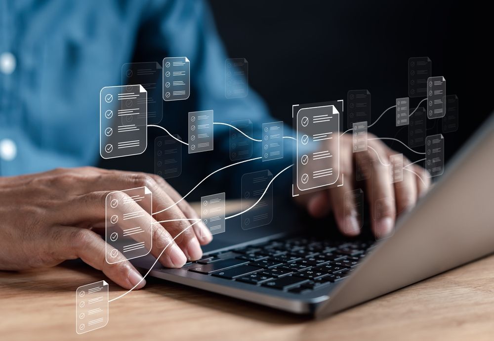 Hands typing on a laptop, surrounded by floating, glowing digital document icons connected by thin, abstract lines.