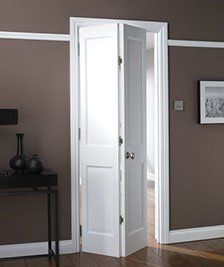 White bi-fold door open in brown room.