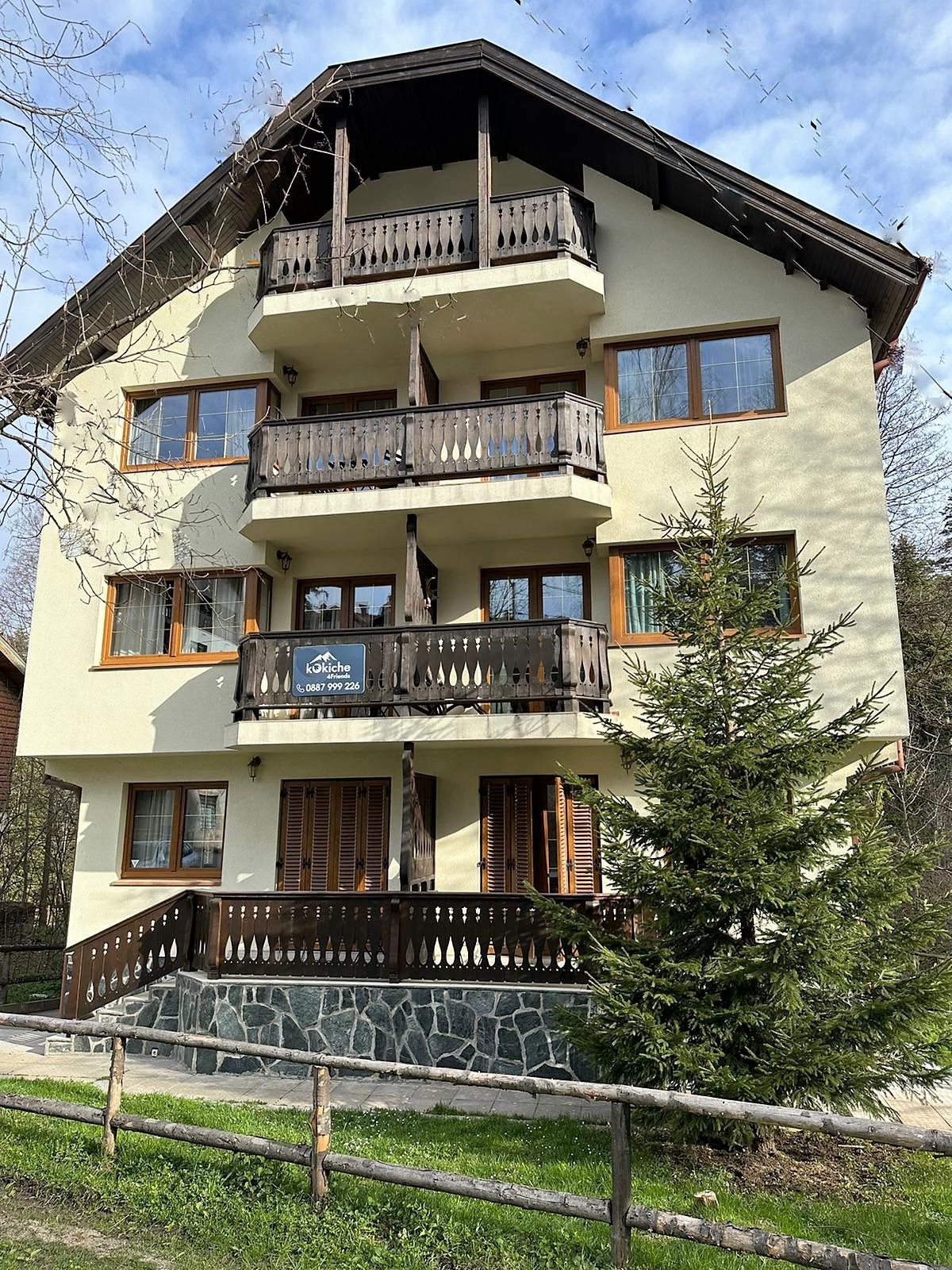 A large house with a wooden fence in front of it.