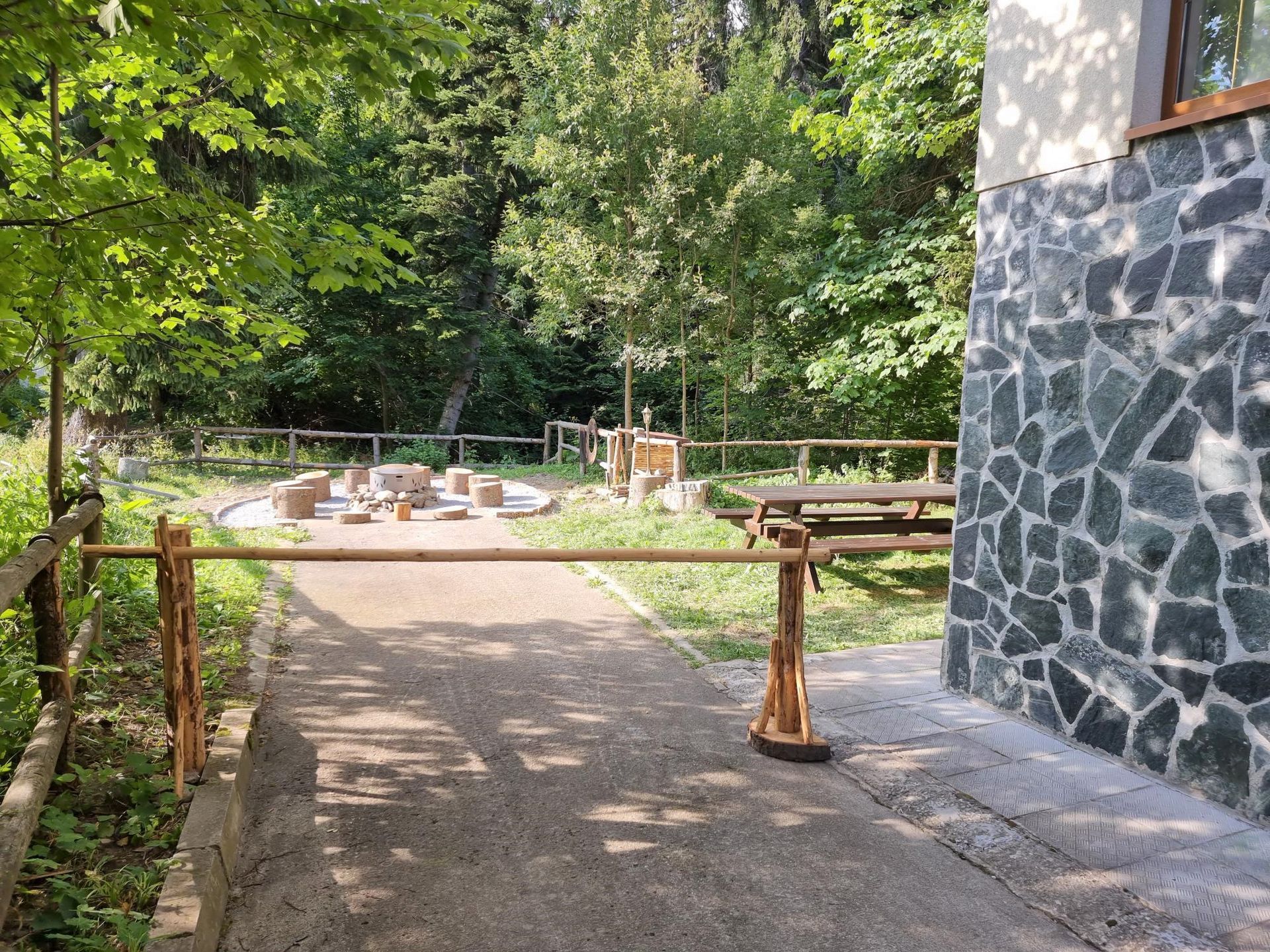 A stone building with a wooden fence in front of it.