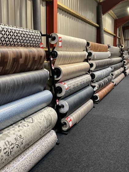 A warehouse filled with rolls of vinyl flooring.