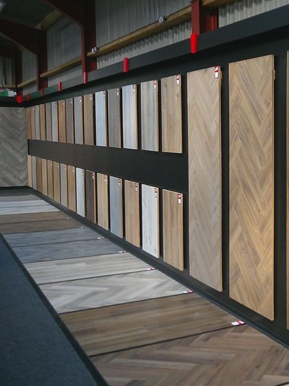 A wall filled with lots of different types of wood samples.