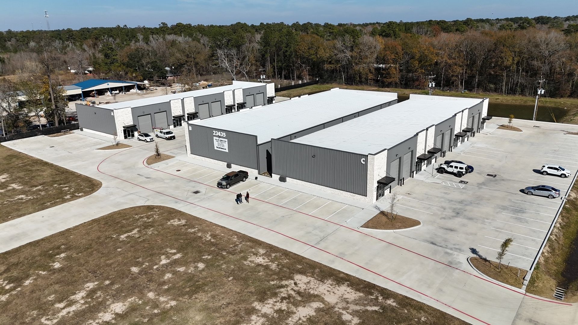 A black label commercial group sign on the side of a road