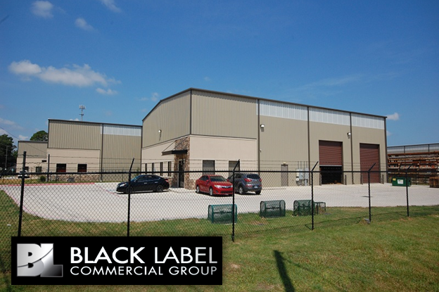 A black label commercial group building with cars parked in front of it
