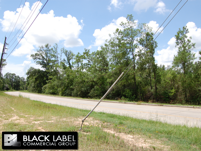 A black label commercial group sign on the side of a road