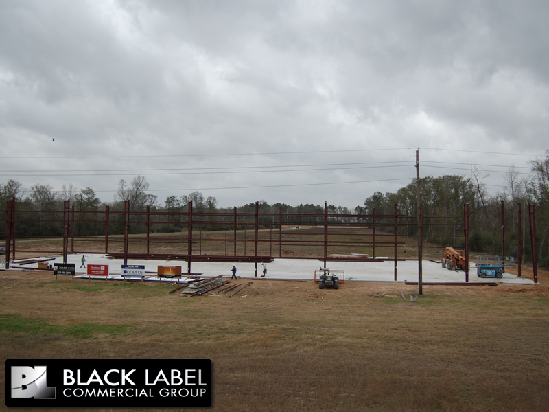 A large metal structure is being built by the black label commercial group