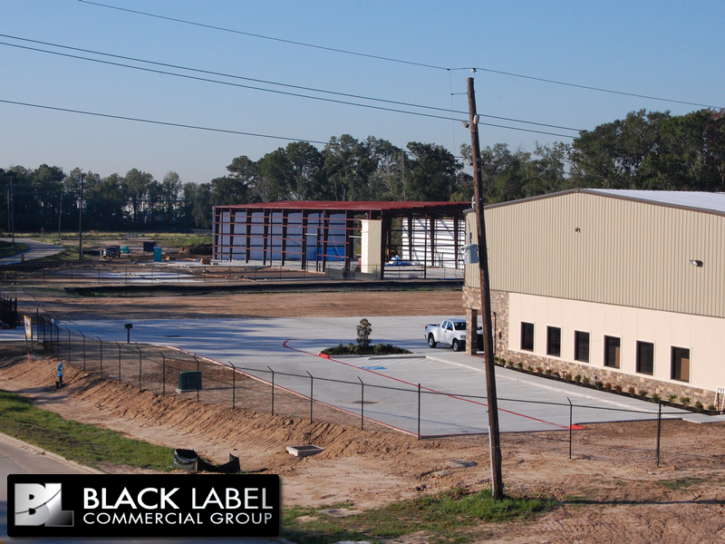 A black label commercial group logo is on the side of a building
