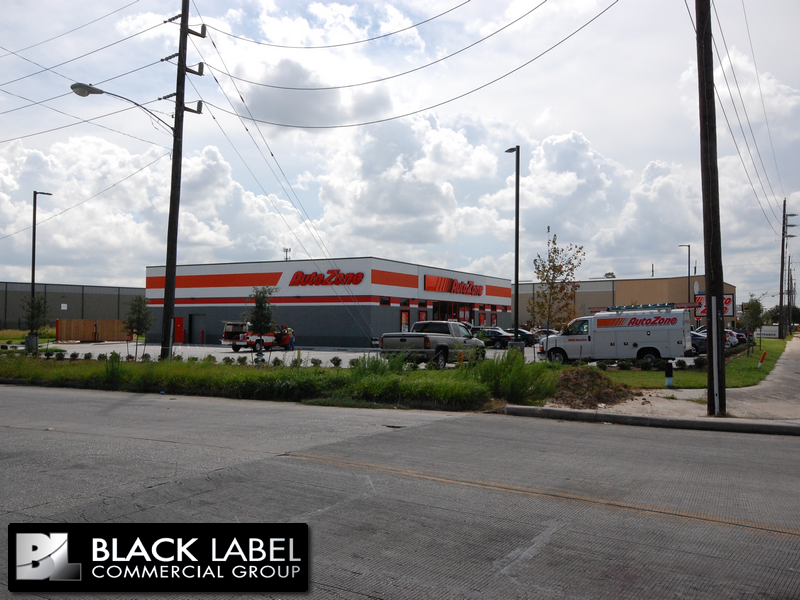 A black label commercial group photo of an auto dealer