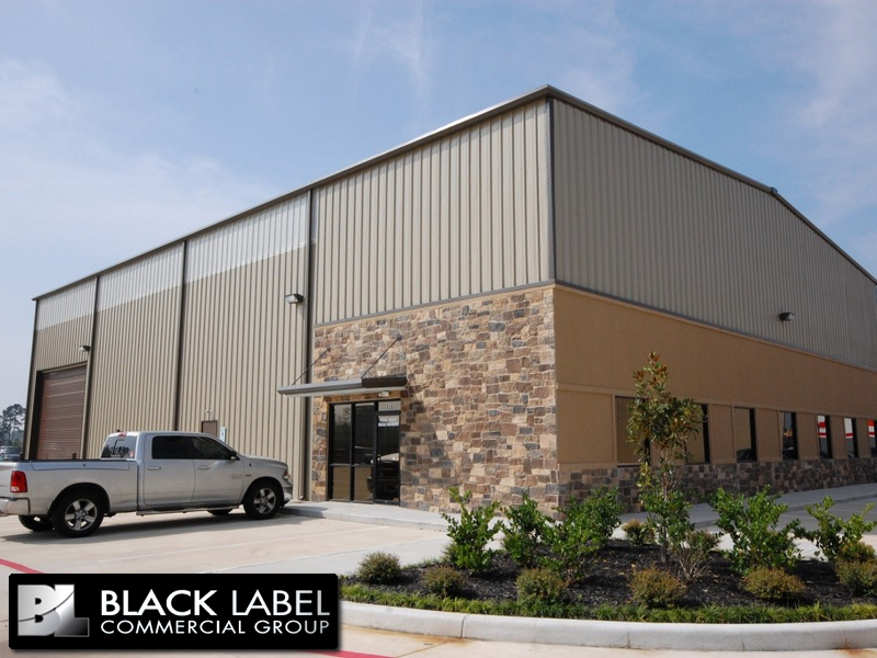 A truck is parked in front of a building that says black label commercial group