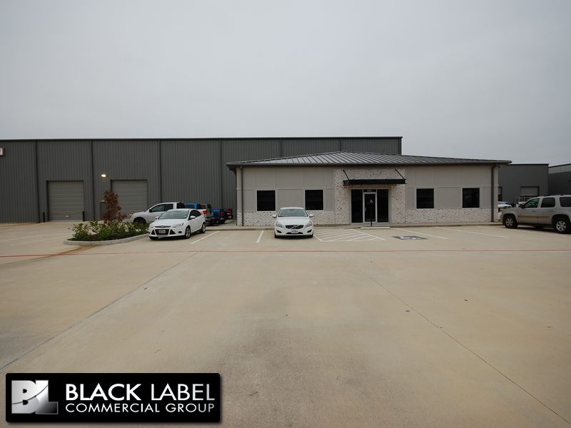 A black label commercial group building with cars parked in front of it