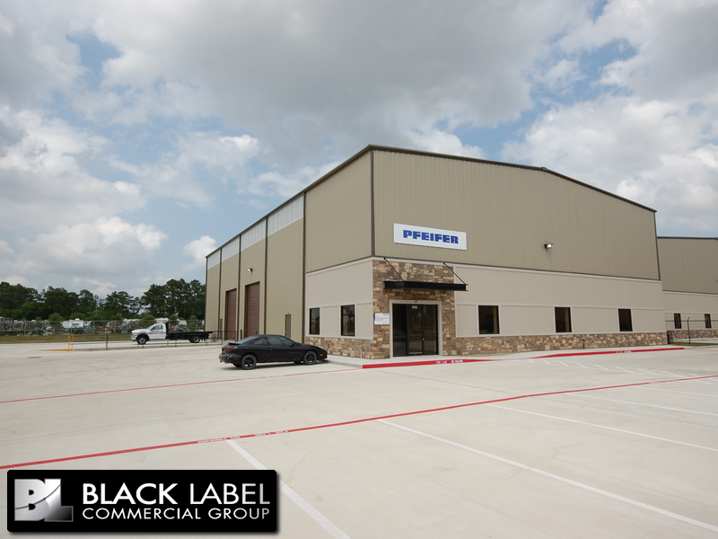 A black label commercial group building with a car parked in front of it