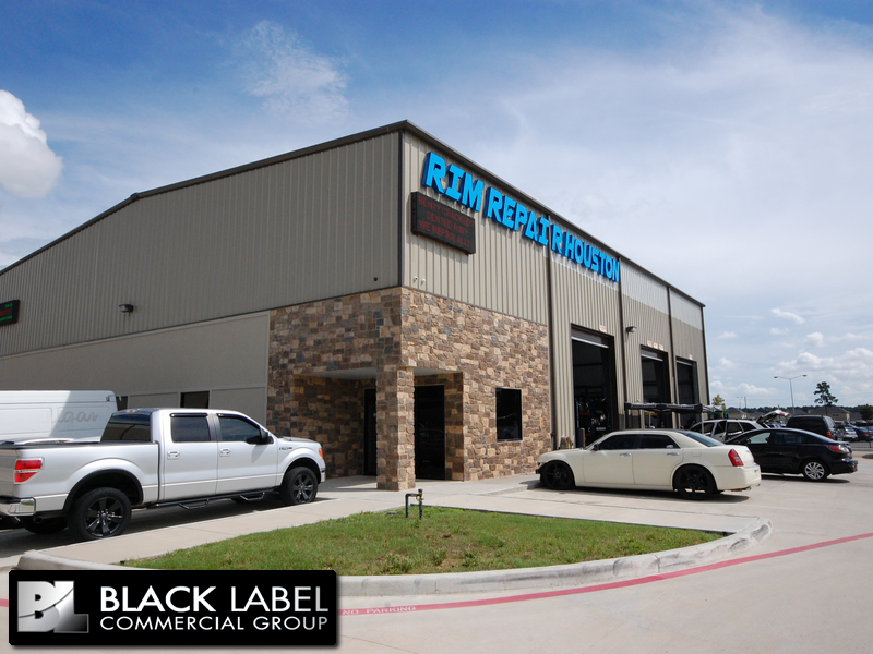 A black label commercial group building with cars parked in front of it
