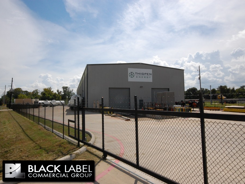 A black label commercial group building with a chain link fence around it