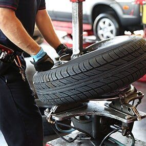 Mechanic Changing Car Tire - Auto Repair in Carmi, IL