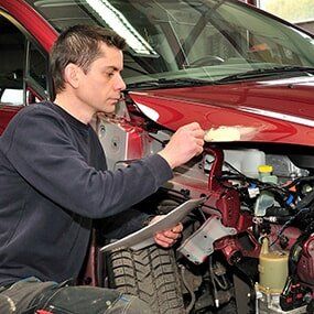 Mechanic Checking Car Damage - Auto Maintenance in Carmi, IL
