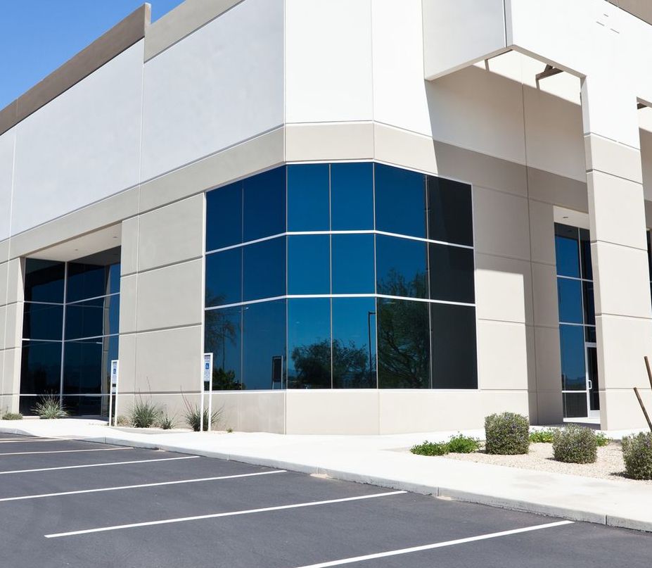 A man and a woman are cleaning an office with a vacuum cleaner.