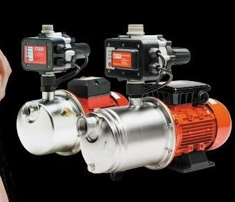 Two water pumps with red and silver components, black control boxes, and a black background. — Bennett's Servicing and Plumbing In South Nowra, NSW