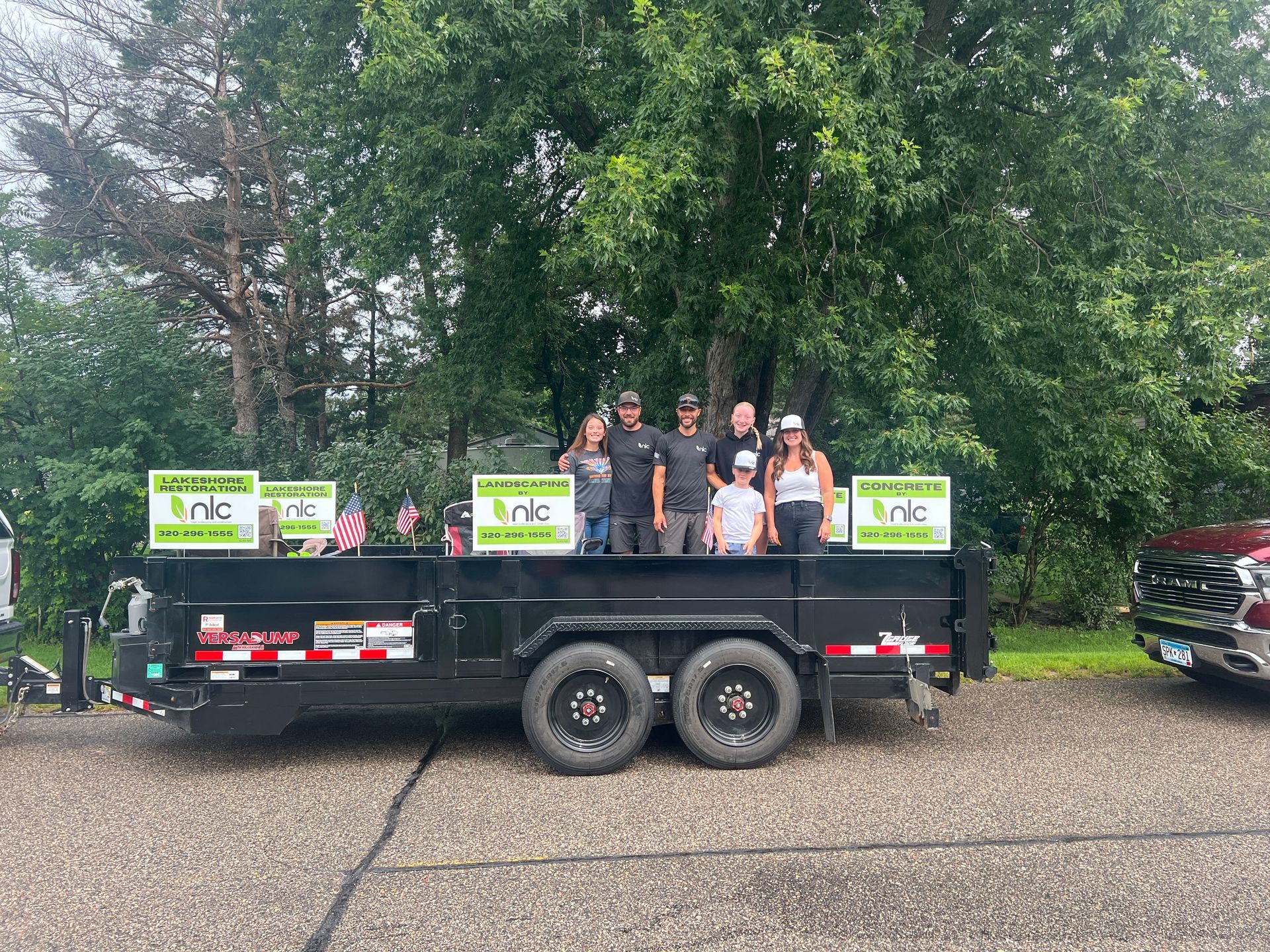 People on a trailer with signs that say