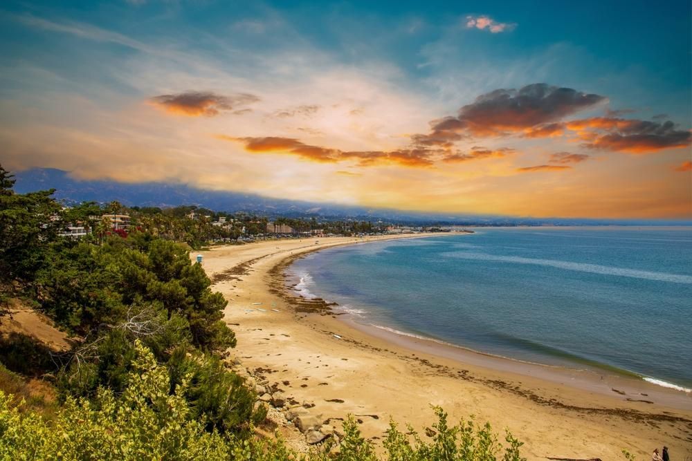 Beach With a Sunset in the Background and Trees on the Shore — Bargara Removals in Bargara, QLD