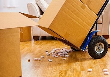 Hand Truck is Carrying Boxes in a Living Room — Bargara Removals in Rubyanna, QLD