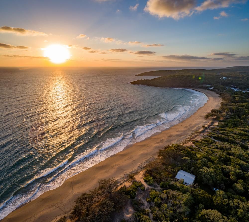Aerial View of a Beach and Ocean at Sunset — Bargara Removals in Hervey Bay, QLD