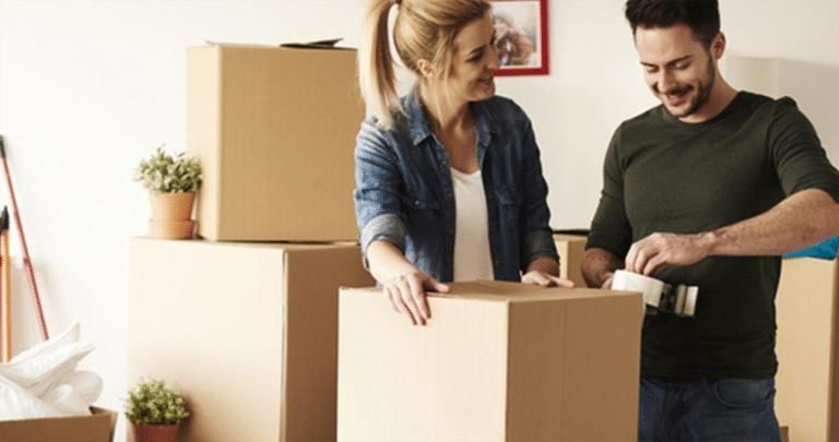 Man and a Woman Are Packing Boxes in a Room — Bargara Removals in Rubyanna, QLD