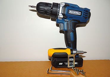 Cordless Drill With a Screwdriver and Screws on a Table — Bargara Removals in Rubyanna, QLD