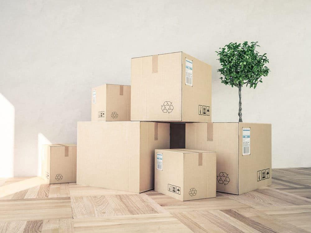 Stack of Cardboard Boxes Sitting on Top of Each Other on a Wooden Floor — Bargara Removals in Rubyanna, QLD