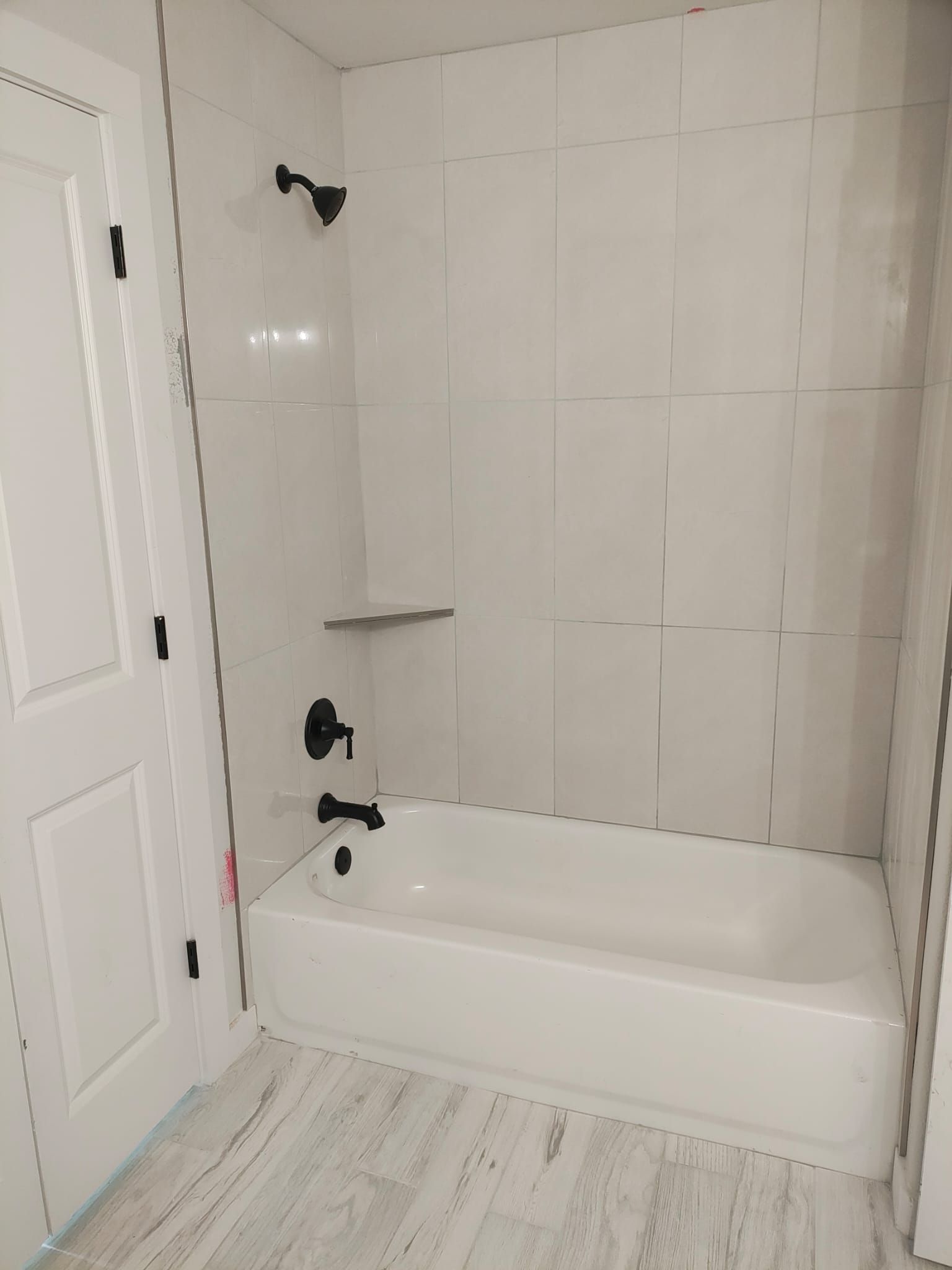 A bathroom with a bathtub and a shower.