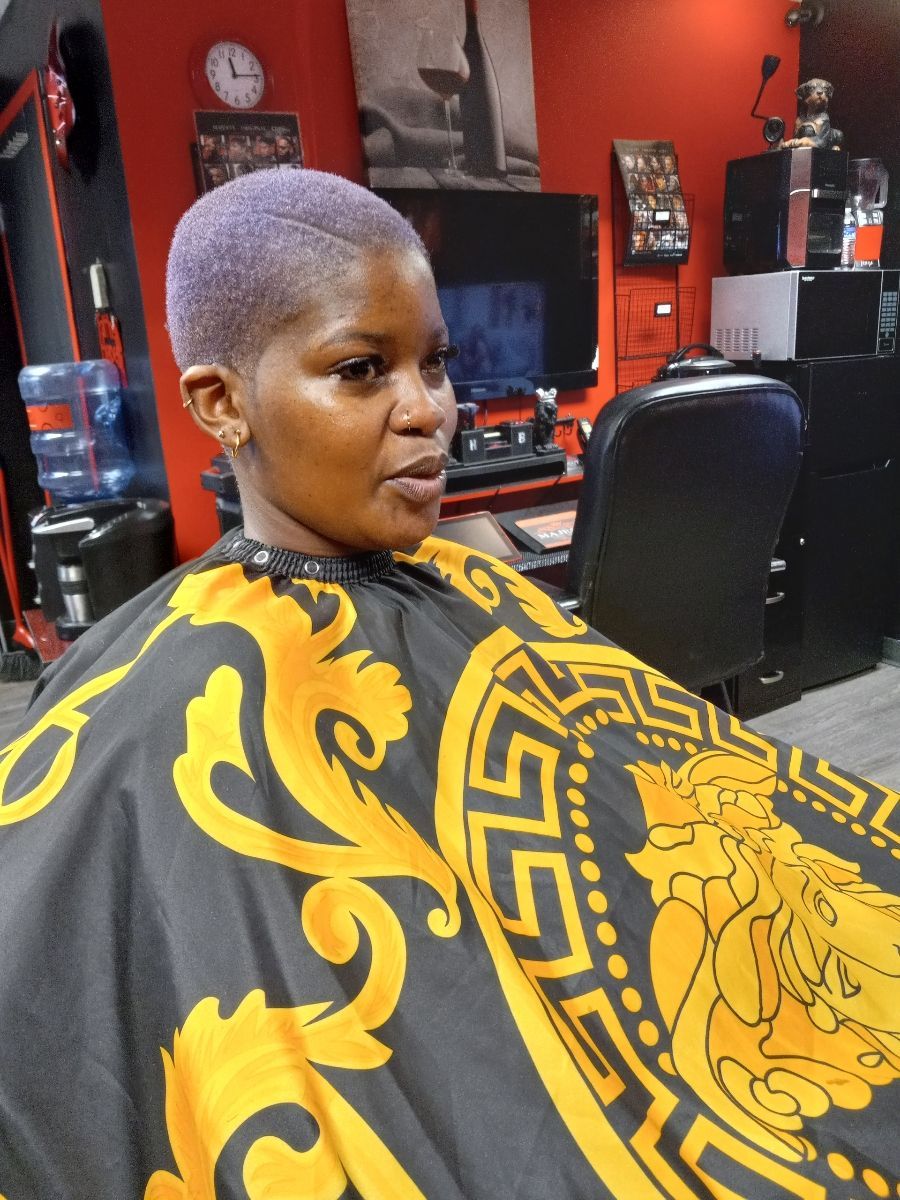 portrait young black man being trimmed